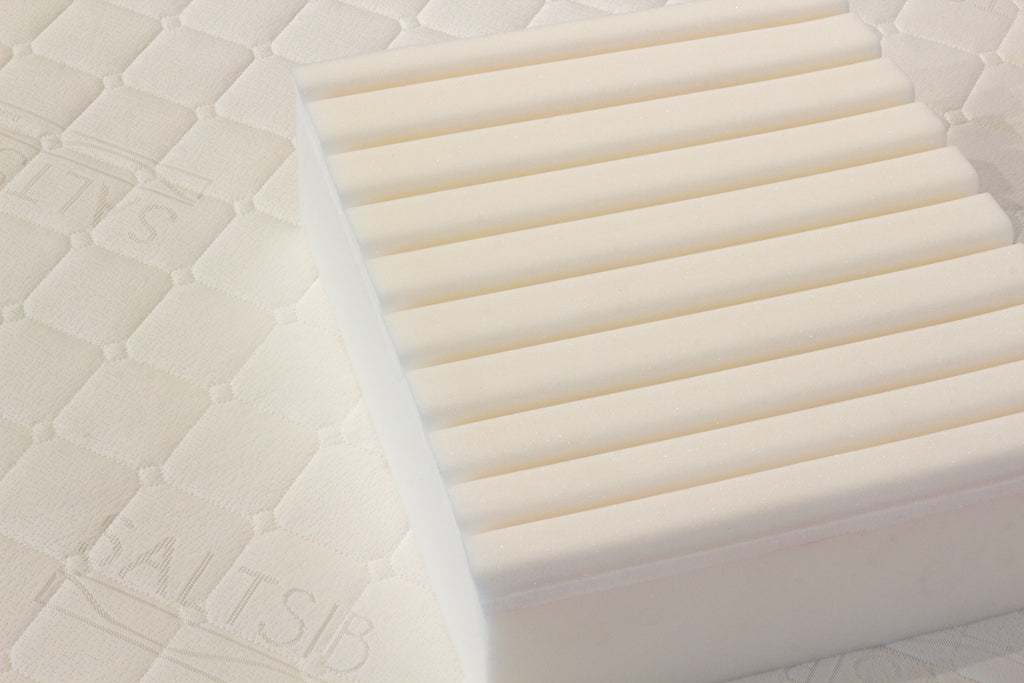 Close-up of a mattress with 'SALTSIB' branding on a textured surface.