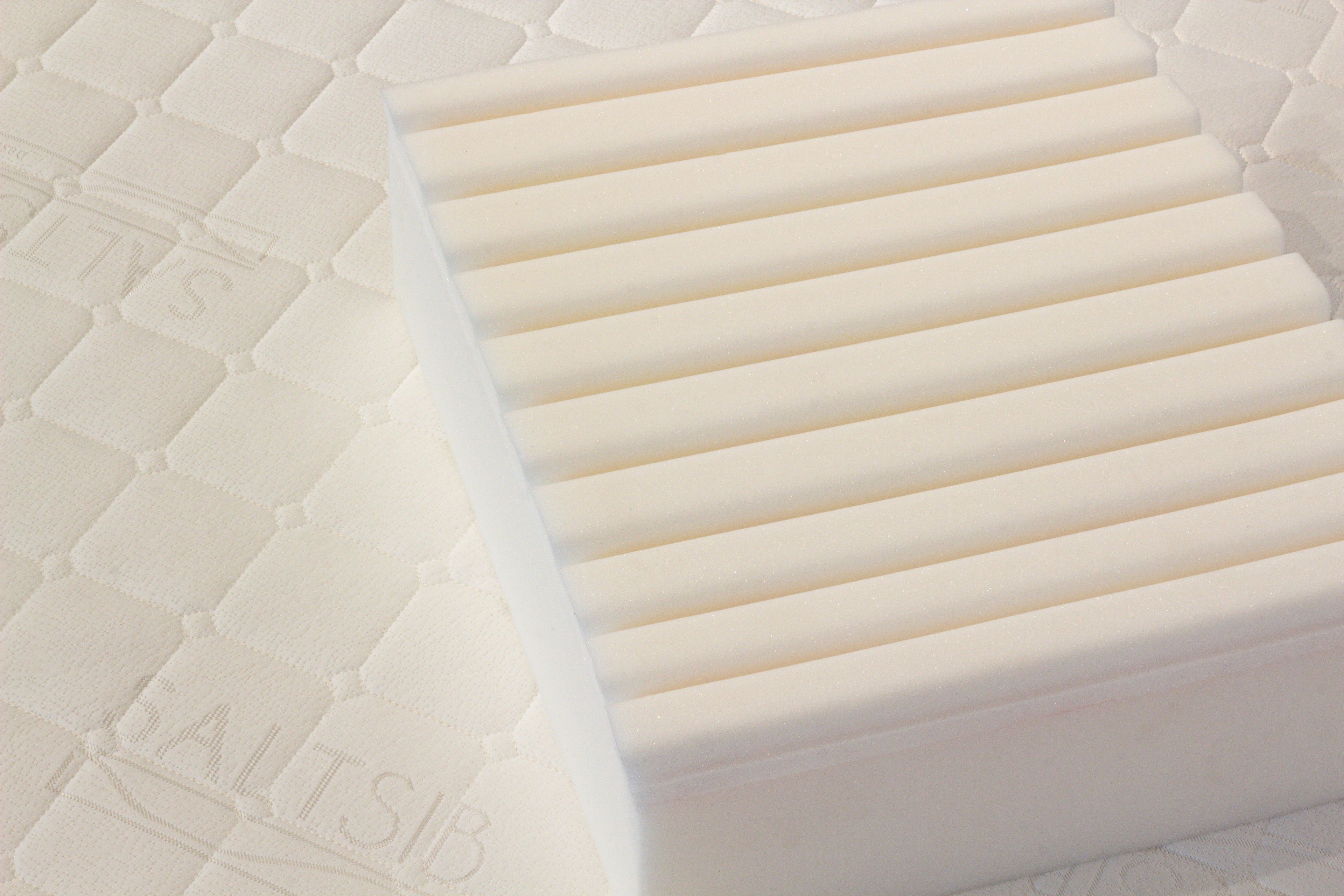Close-up of a mattress with 'SALTSIB' branding on a textured surface.