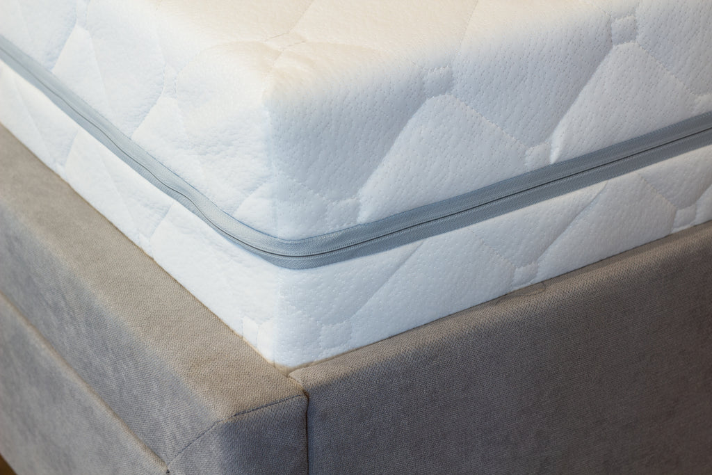 White mattress on a bed