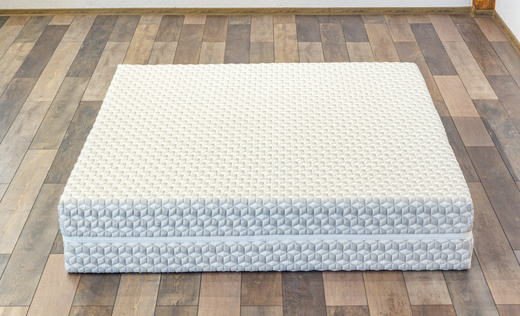 White mattress on a wooden floor