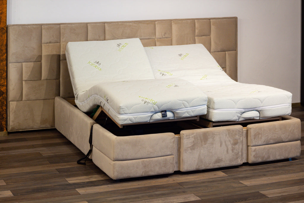 Beige adjustable bed with mattress in a room setting