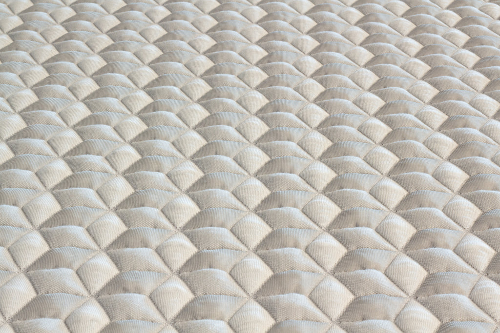 Close-up of a textured beige fabric with diamond pattern
