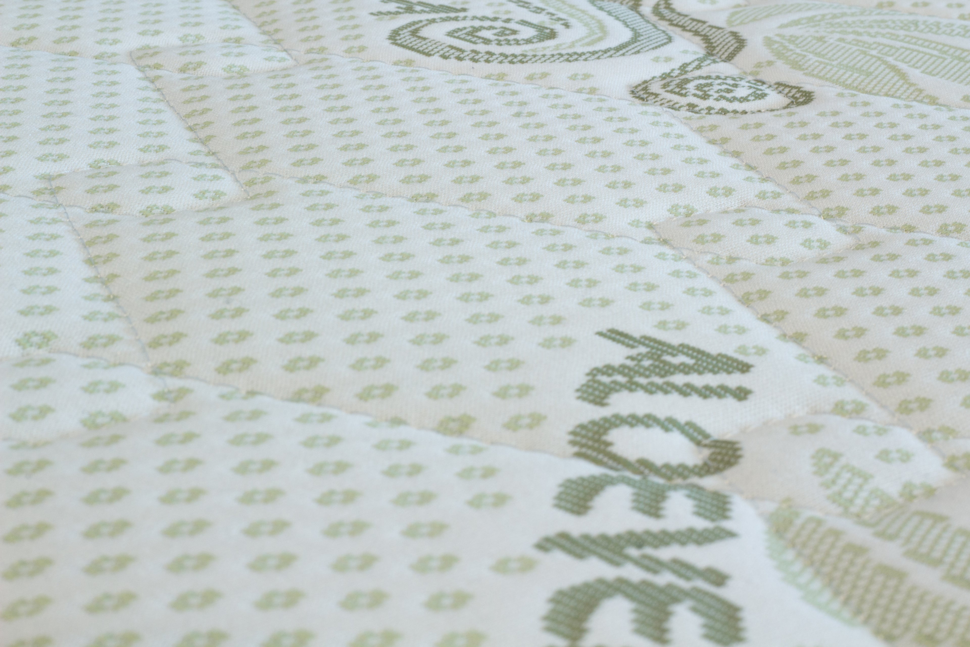 Textile with a pattern and the word 'Aloe vera' embroidered on it.