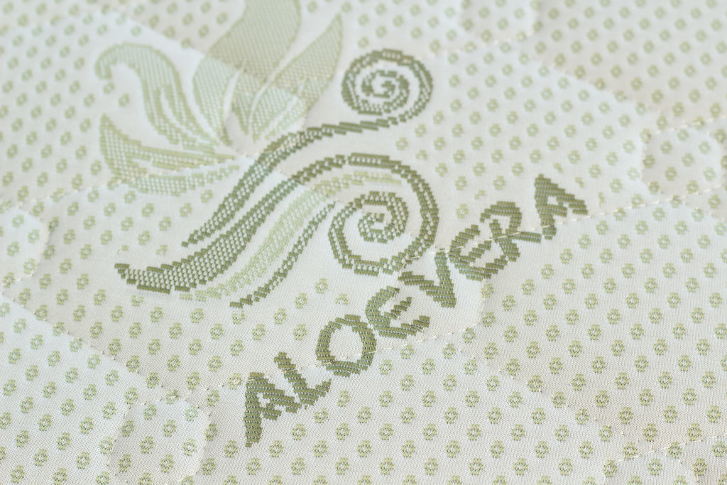 Textile with 'Aloe vera' branding and decorative design on a light background