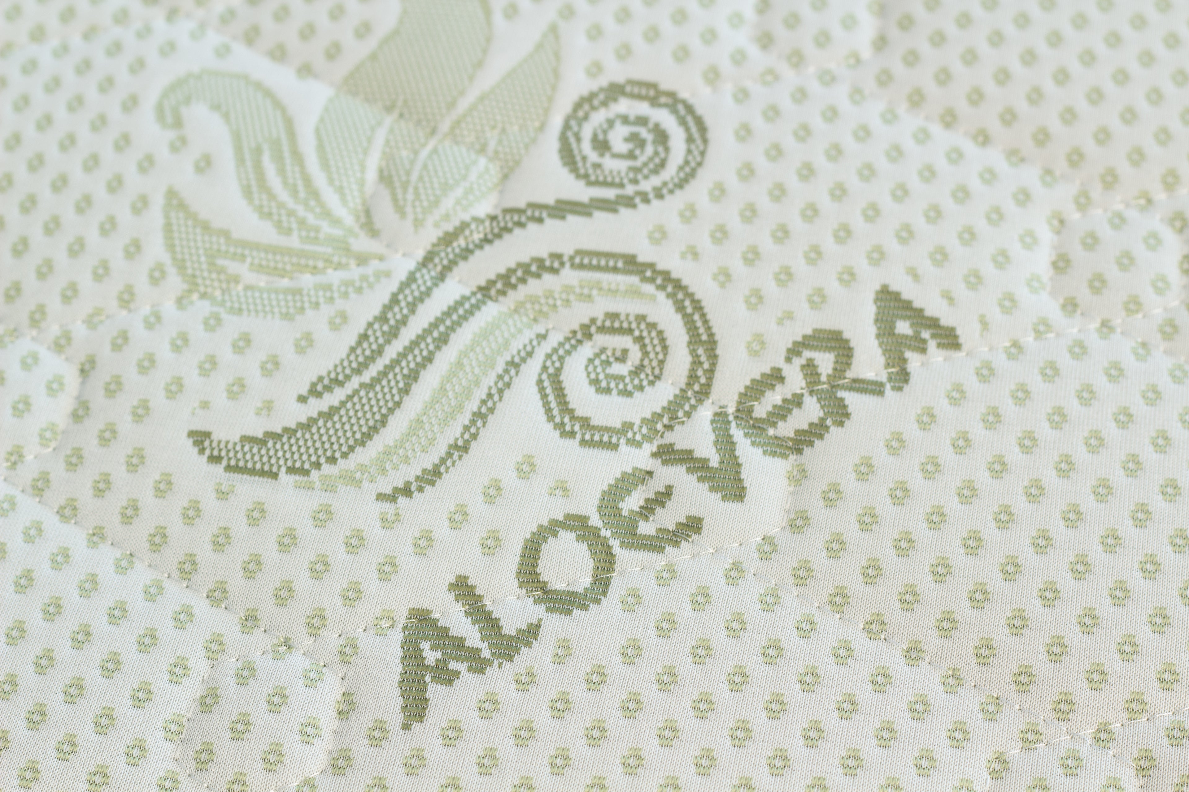 Textile with 'Aloe vera' branding and decorative design on a light background