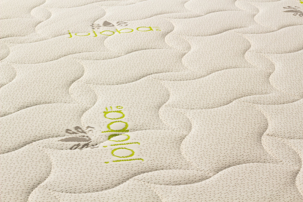 Close-up of a textured mattress surface with 'jojoba' branding.