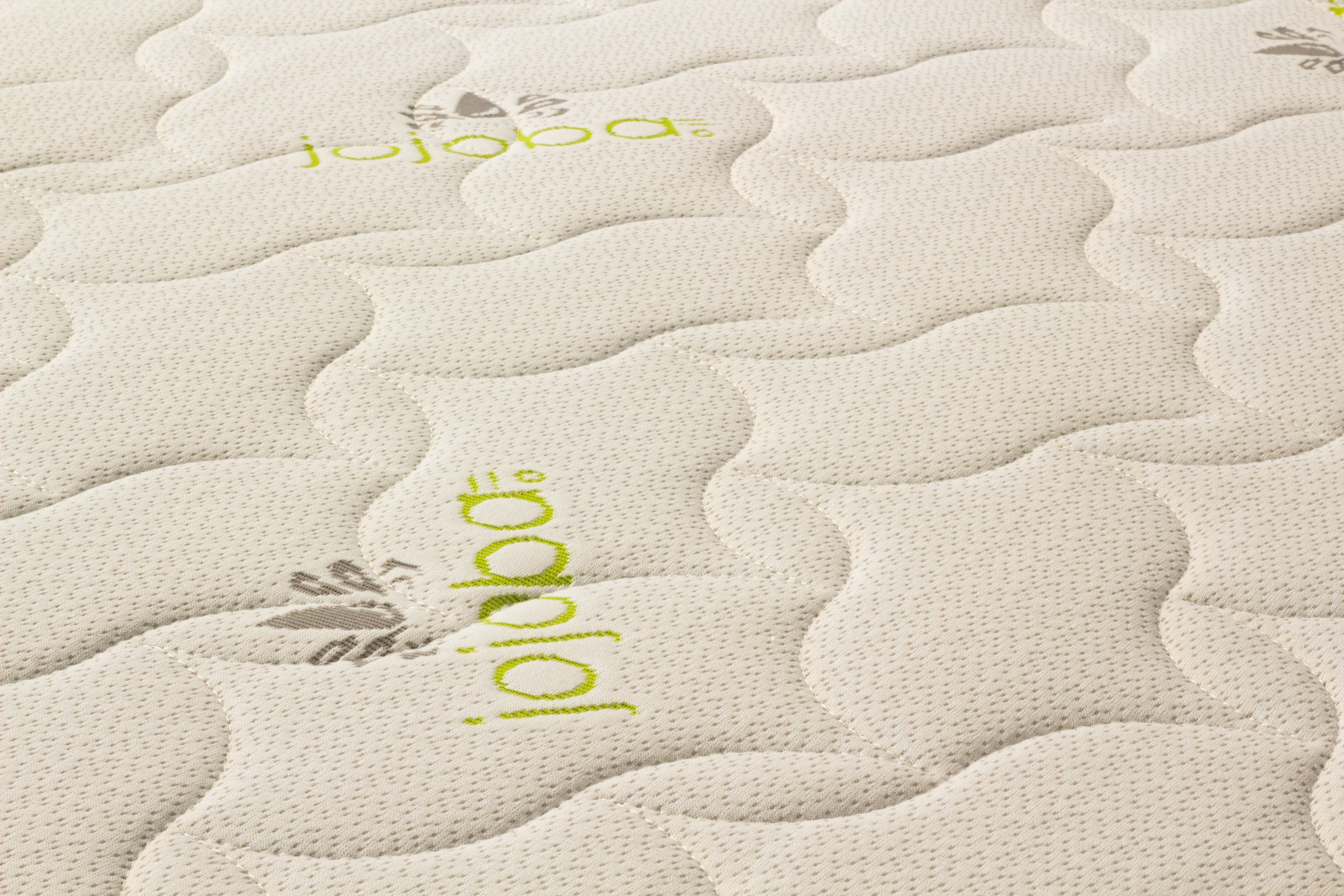 Close-up of a textured mattress surface with 'jojoba' branding.