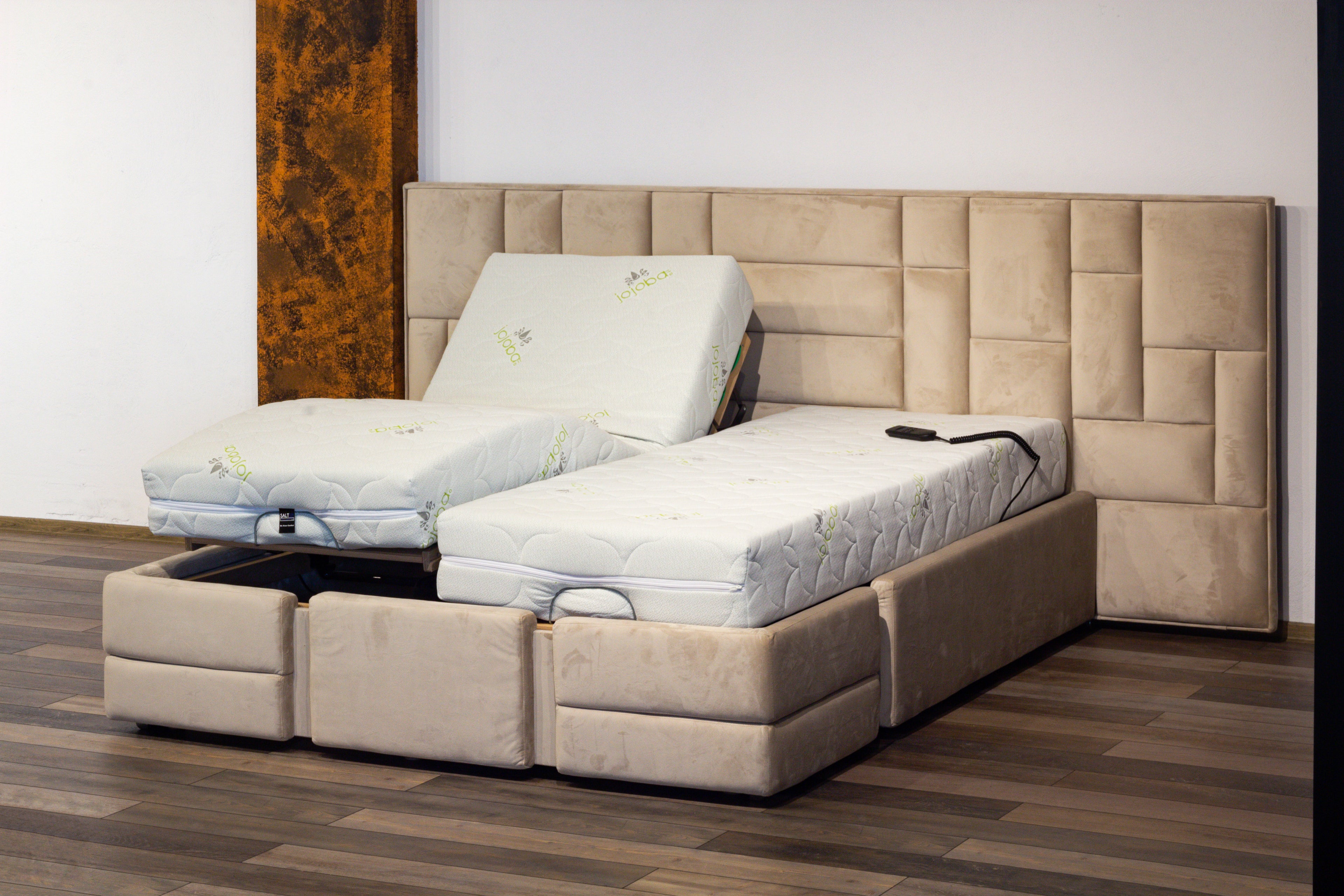 Beige bed with mattress and headboard in a room setting