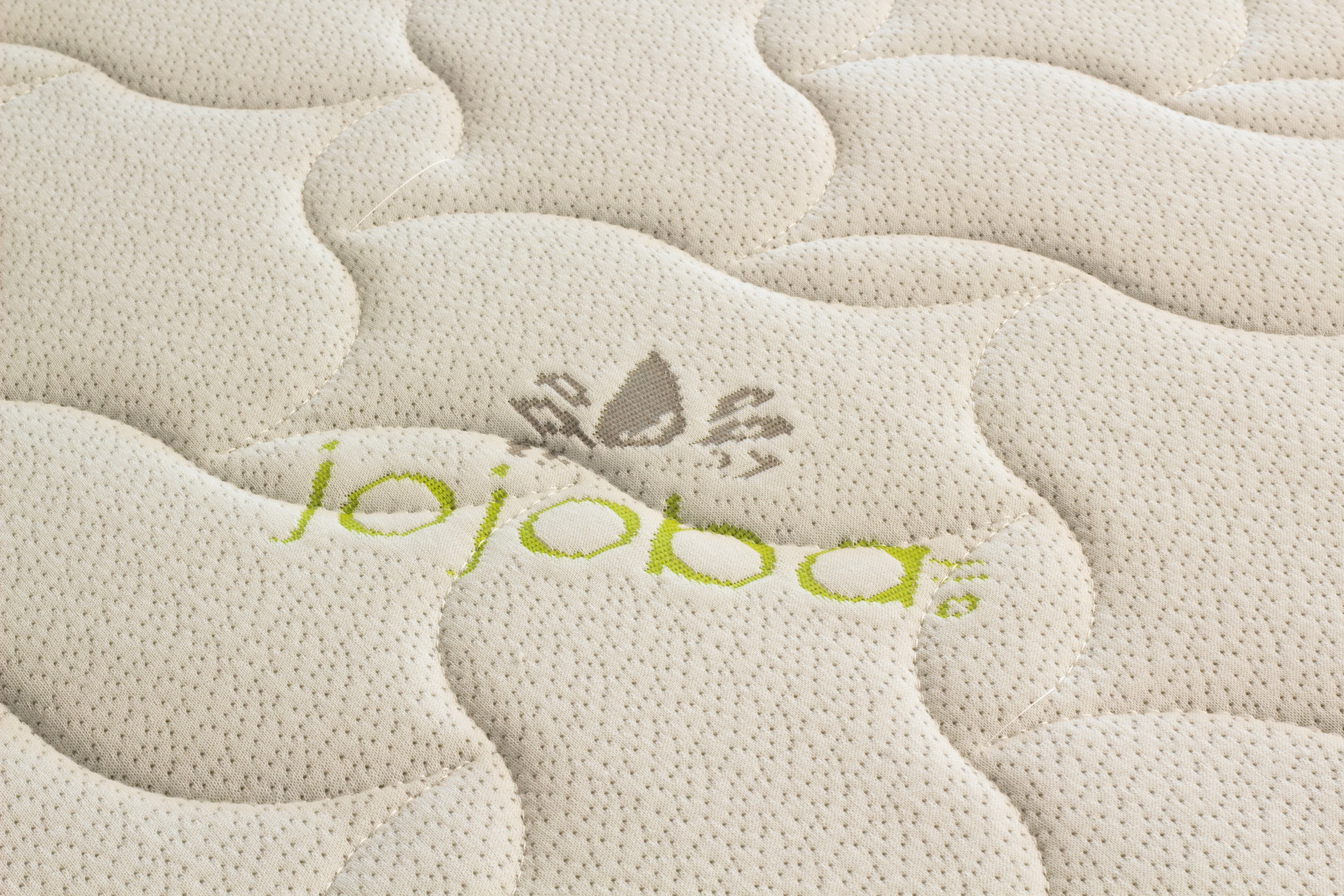 Textured surface with 'jojoba' branding and a logo.