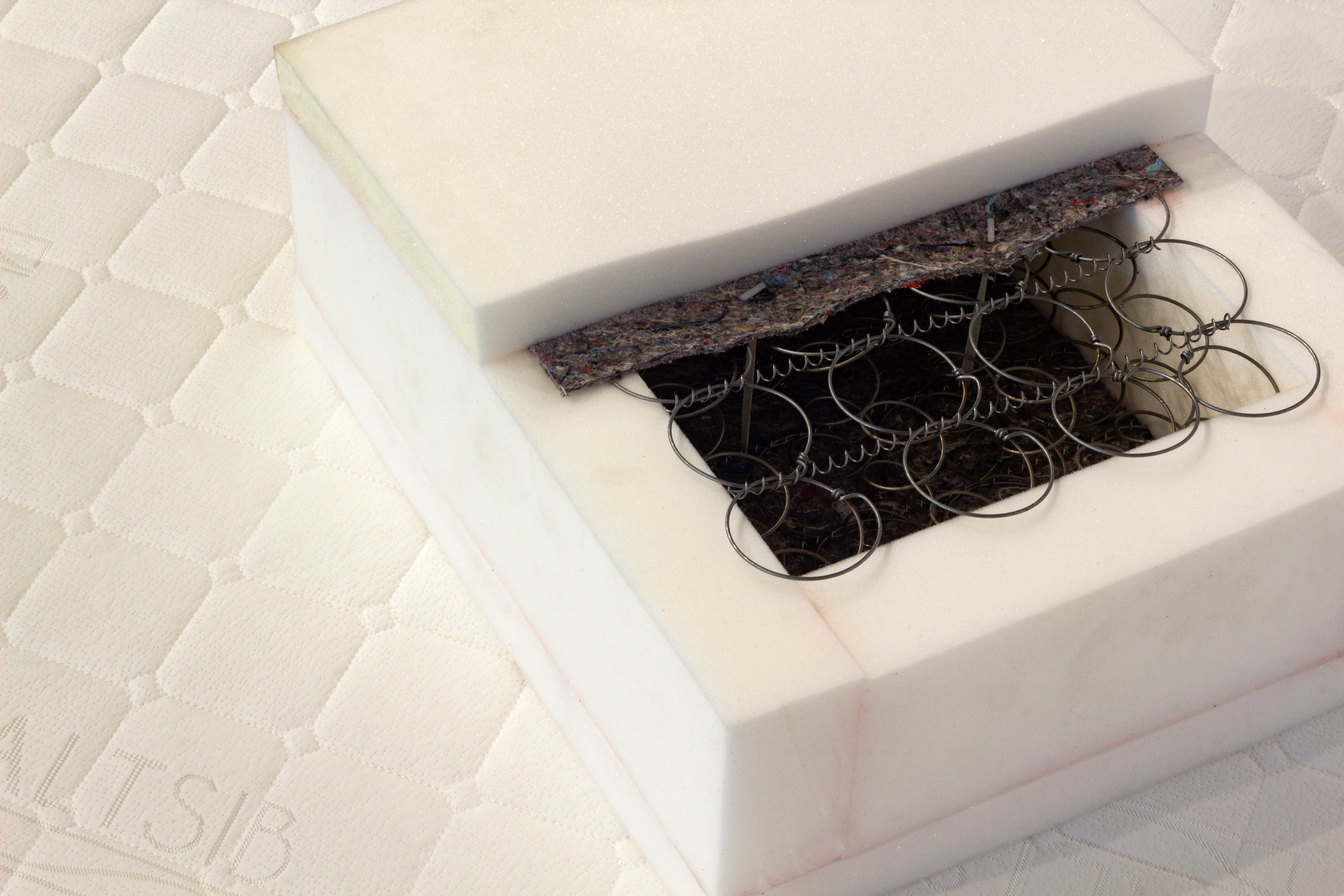 Close-up of a mattress with a box spring and coils visible